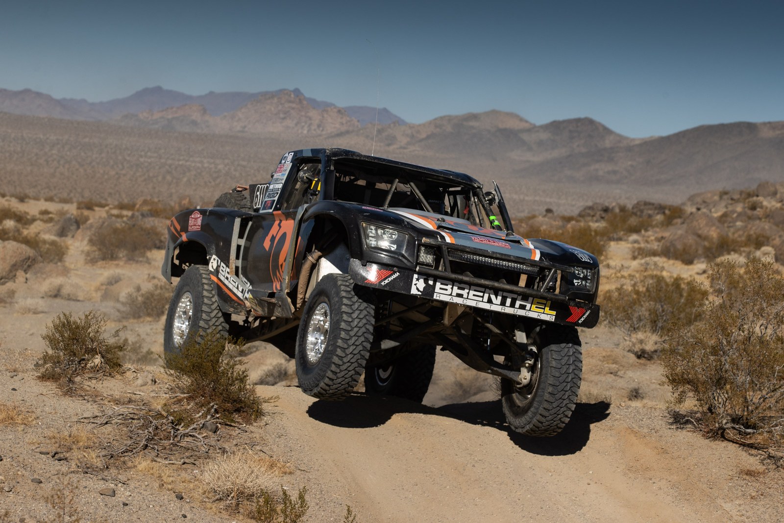 Brenthel trophy truck No. 6110 airborne in the desert, King of the Hammers 2025