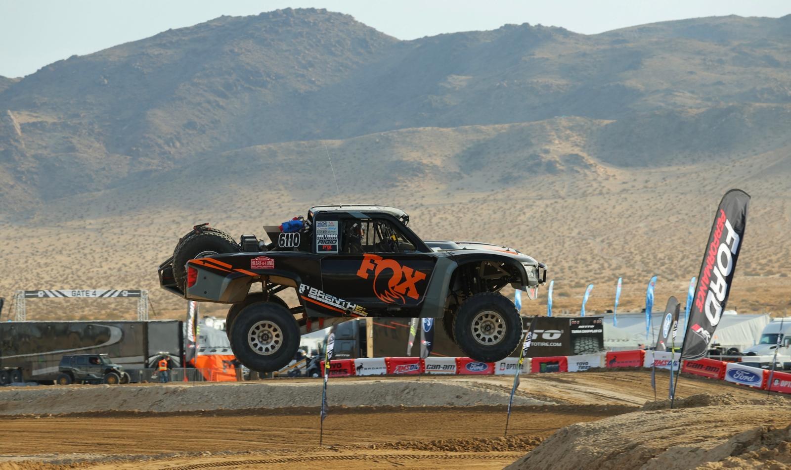 Brenthel trophy truck No. 6110 over a jump, King of the Hammers 2025